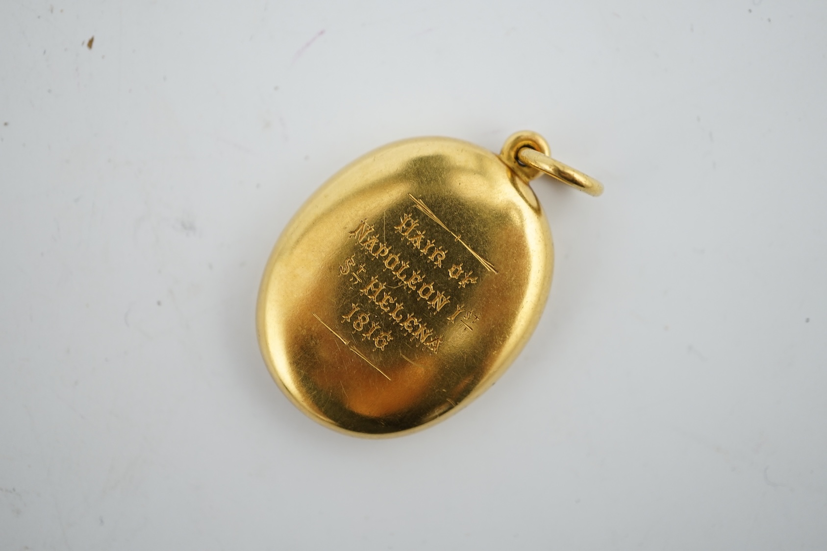 A yellow metal locket containing a lock of Napoleon I hair